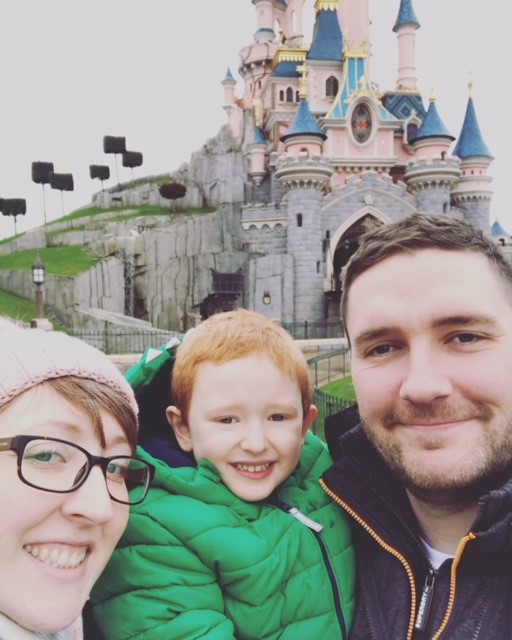 Mummy, Daddy and little boy with the Disneyland Paris castle in the background