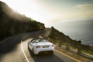 white ferrari car on road sea view