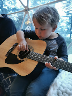 Boy playing guitar, Haida Gwaii