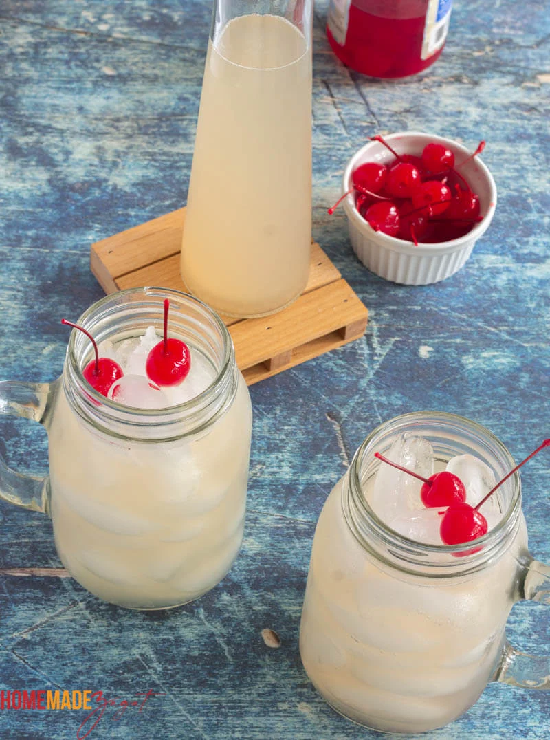 Glasses and mugs of guava juice with cherries