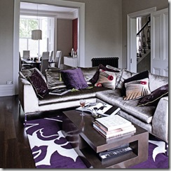 Open plan grey through lounge living room dining room silver sofas decorative purple rug coffee table pendant lamp shades assorted cushions real home L etc 09/2007 pub orig 