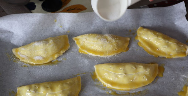 liberally adding sugar to the chaussons aux pommes before they are baked