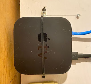 Apple TV, secured with two clips and one tie.