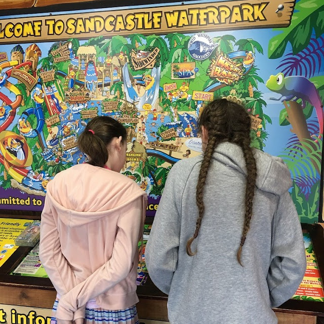 stephs two girls looking at sandcastle waterpark map