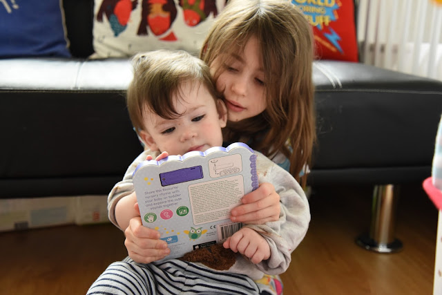 Reading with his sister