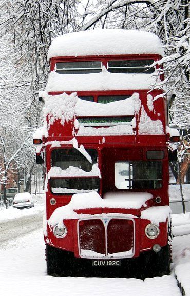 Snow covered red double-decker bu