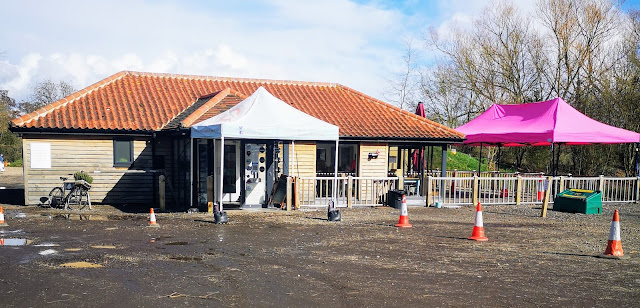 Image shows a single story tearoom and cafe that has an outdoor seating area and has clearly marked covid 19 compliant protocol in place.