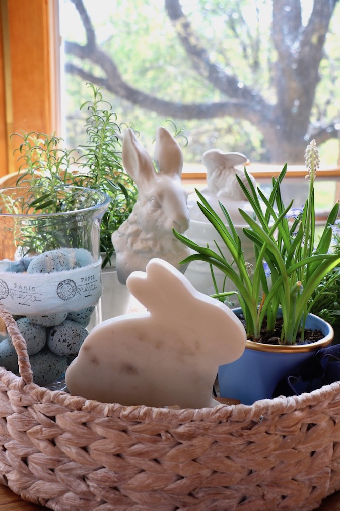 Three white bunnies are adorable as part of a Spring Blue and White Basket Arrangement