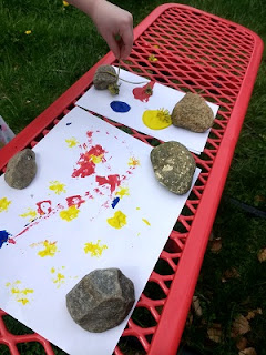 Child making process art with wildflowers