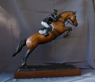 Bronze jumping horse sculpture leaping into the air.