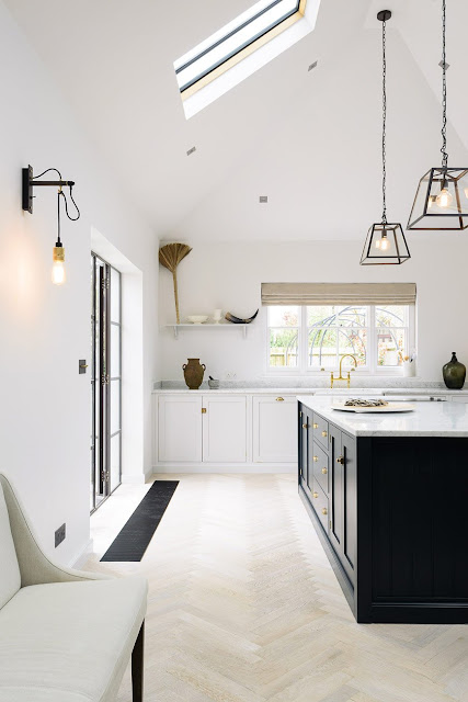 Minimal modern farmhouse kitchen with Shaker cabinets, high ceilings and modern lighting - found on Hello Lovely Studio