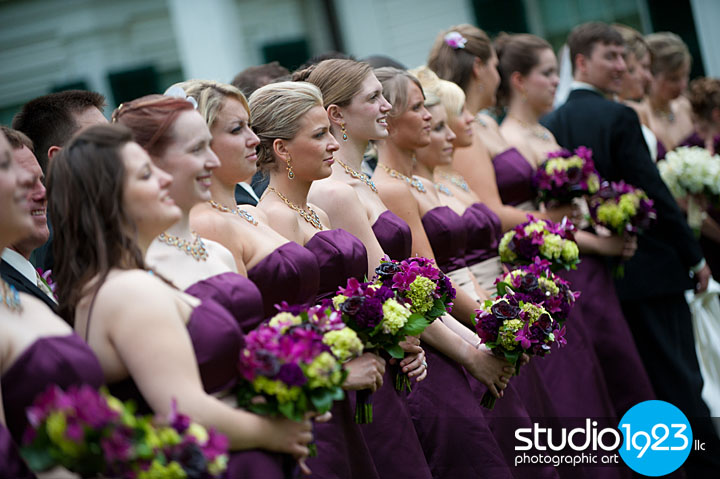 The bridesmaids wore eggplant color gowns and carried vibrant flowers in