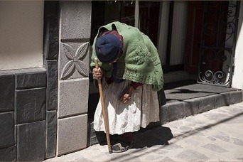 Hunchbacked old woman in Puno, Peru.