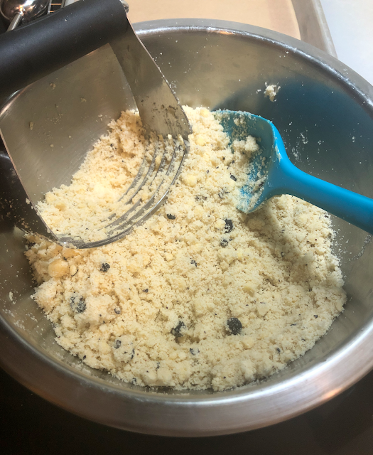 Cutting the butter cubes into the dry baking mixes with a pastry blender