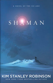 Book Cover: Shaman by Kim Stanley Robinson. A small figure stands silhouetted on a giant mound of snow