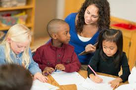 A woman and three children sitting at a table in a room. It is about masters of educational psychology, masters, psychology, education, educational, educational psychology, online.