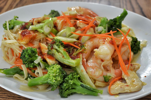 Noodle stir fry with chicken, shrimp, and broccoli