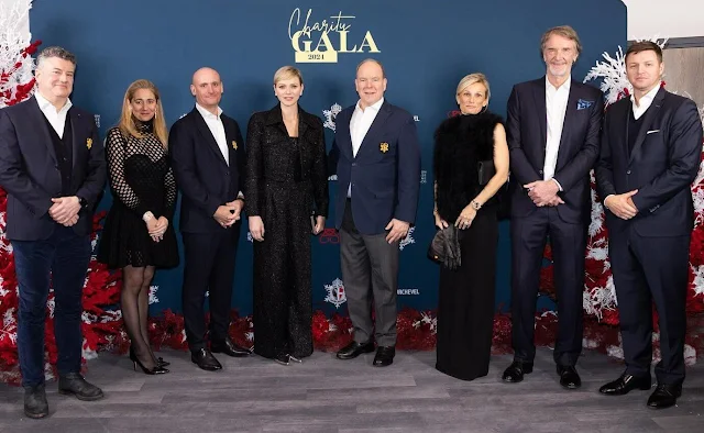 Princess Charlene wore a navy blue boucle cropped jacket pantsuit by Akris, wide-leg trousers by Ralph Lauren