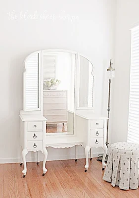 The upholstered vanity stools adds a touch of softness and provides a sense of scale.