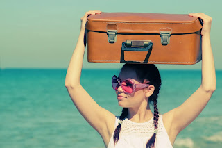 Woman with suitcase by the sea waiting for transport or help