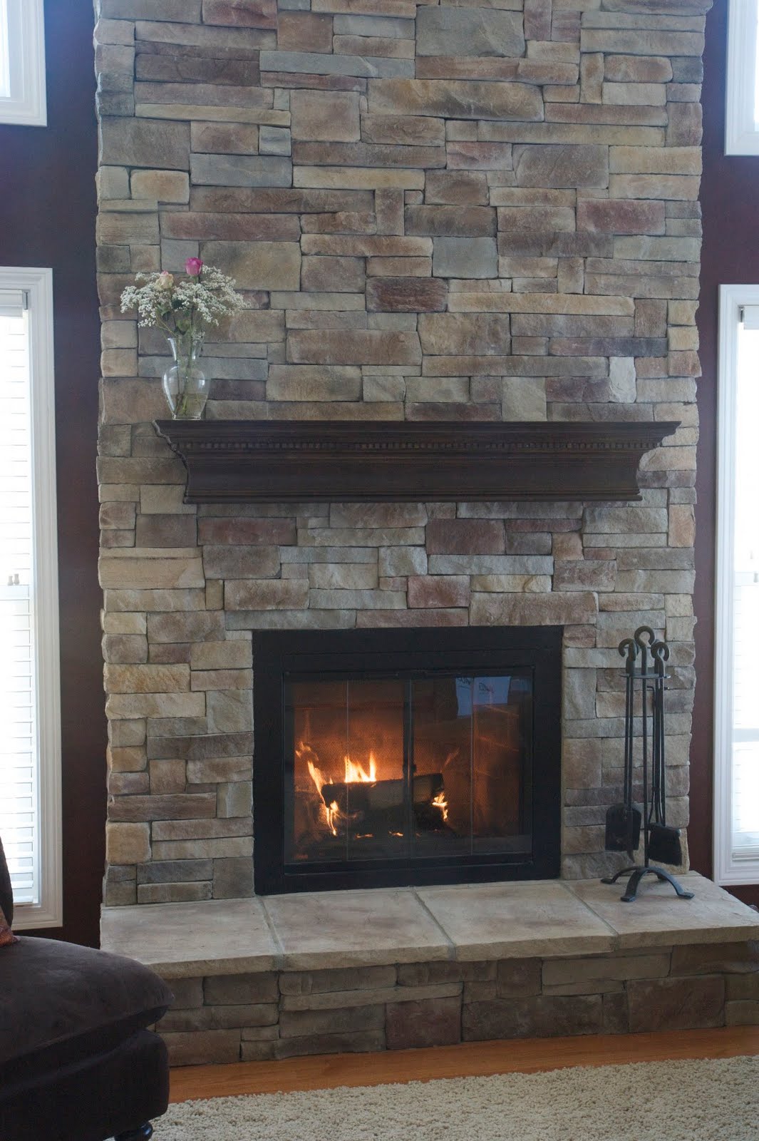 Brick fireplace refurbished with new stone veneer. The manufactured  title=