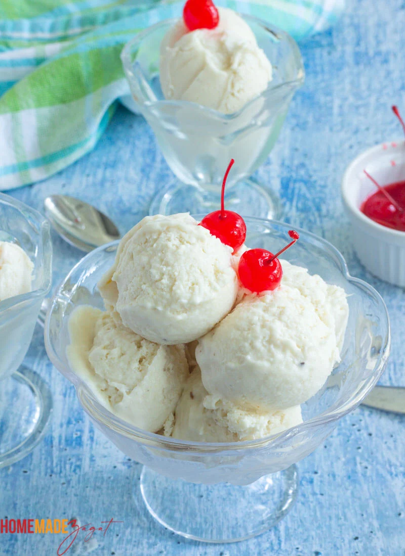 Glasses of soursop ice cream with cherry toppings. With a blue checkered cloth