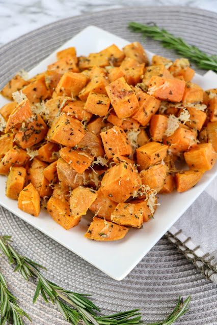 potatoes on a square white plate with gray background.