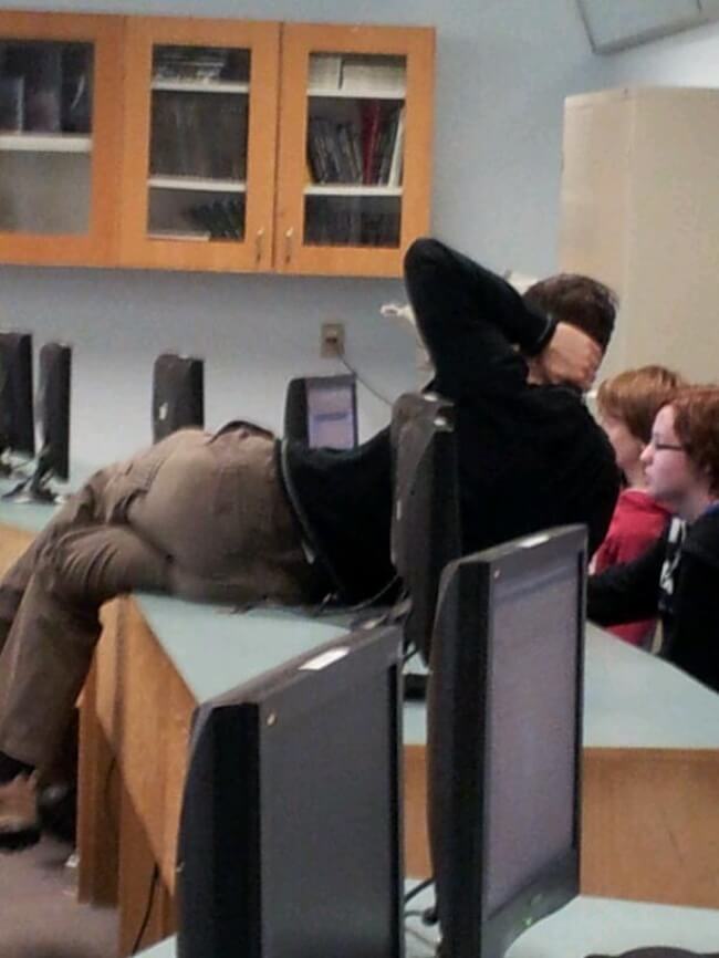 16 Inspiring Photos Prove That Teachers Can Have A Great Sense Of Humor - Why not lie down on the table It is easier than leaning across it.