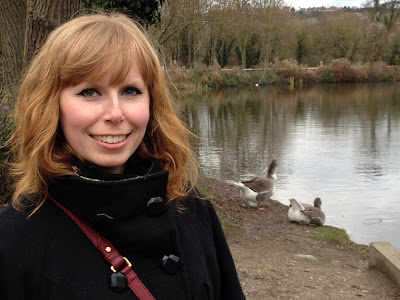 Kat outside by a lake