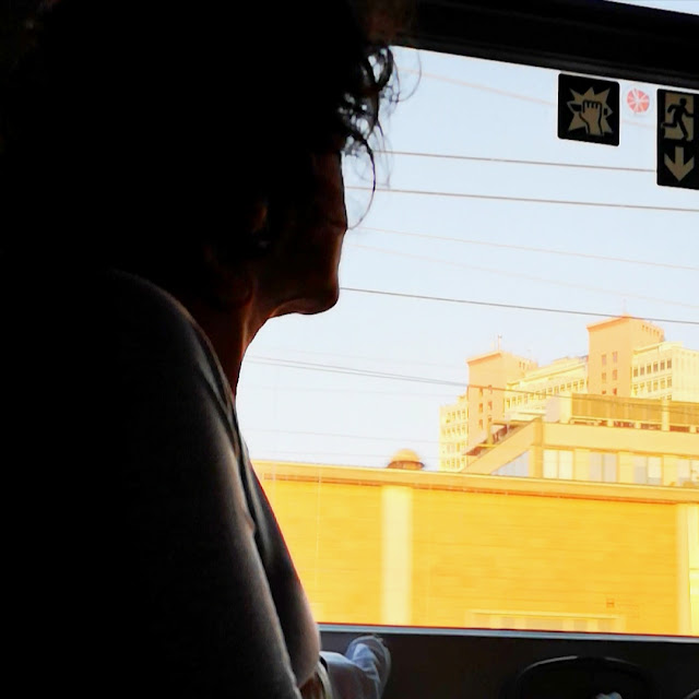 Donna controluce che guarda fuori dal finestrino del treno