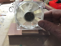 Setting the fan on top of the bottom with a piece of scrap cedar