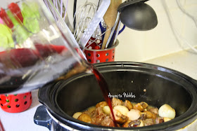 Adding wine to the slow cooker for Beef Bourguignon from www.anyonita-nibbles.com