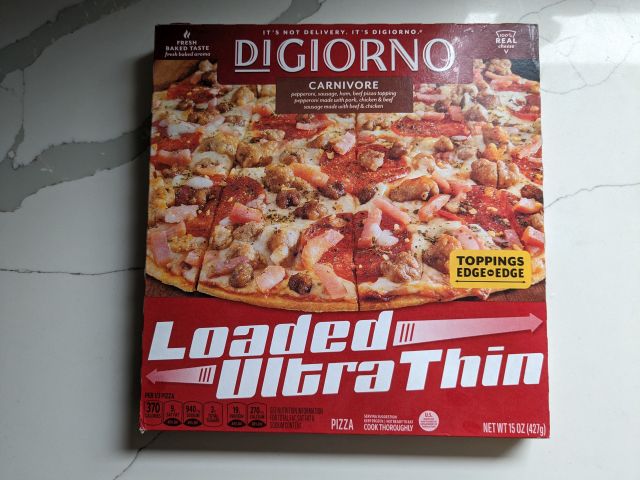 A box of DiGiorno's Carnivore Loaded Ultra Thin Crust Pizza.