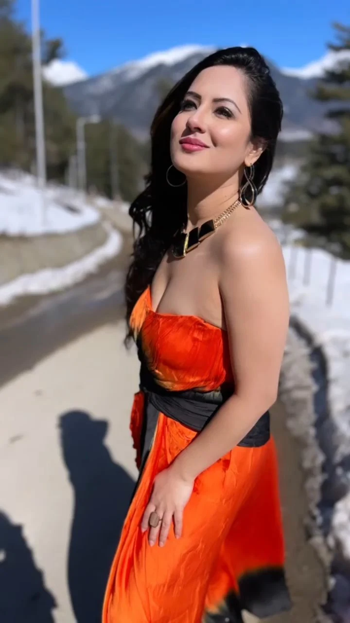 Puja Banerjee cleavage orange dress