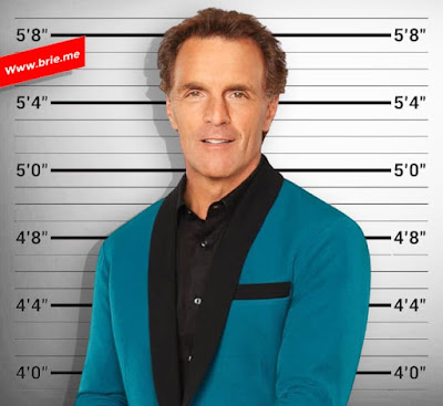 Doug Flutie standing in front of a height chart