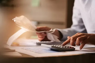 Tax documents stamped “Reduced” with calculator beside ‎