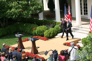 President George W. Bush and Prime Minister Tony Blair of the United Kingdom, walk to the podiums Thursday, May 17, 2007, to begin their joint press availability in the Rose Garden. The visit by Prime Minister Blair marks his last visit in that capacity following his announcement that he'll leave office in June. White House photo by Shealah Craighead 