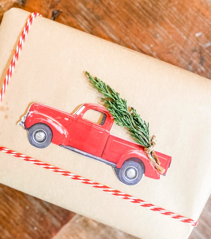 red truck and fresh Christmas greenery on wrapped package