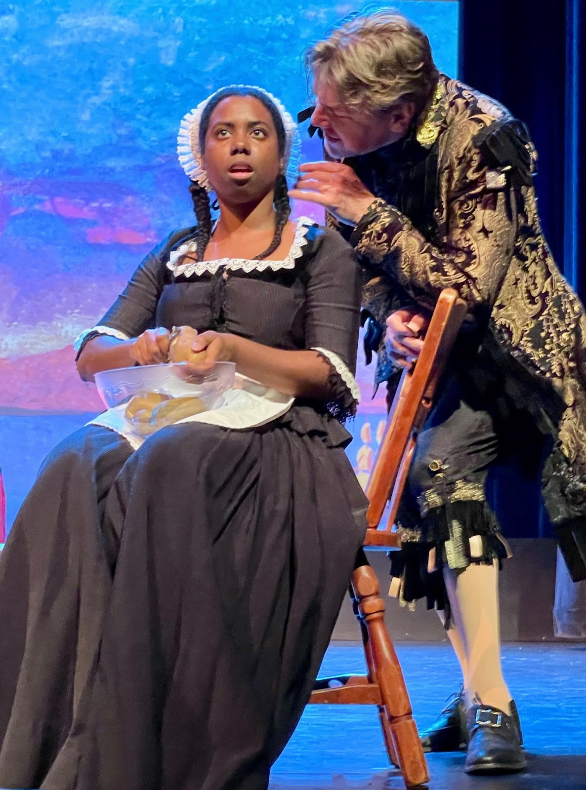IN REVIEW: soprano KYAUNNEE RICHARDSON as Despina (left) and bass DENIS SEDOV as Don Alfonso (right) in Opera in Williamsburg's 2022 production of Wolfgang Amadeus Mozart's COSÌ FAN TUTTE [Photograph by Roxane Revon, © by Opera in Williamsburg]