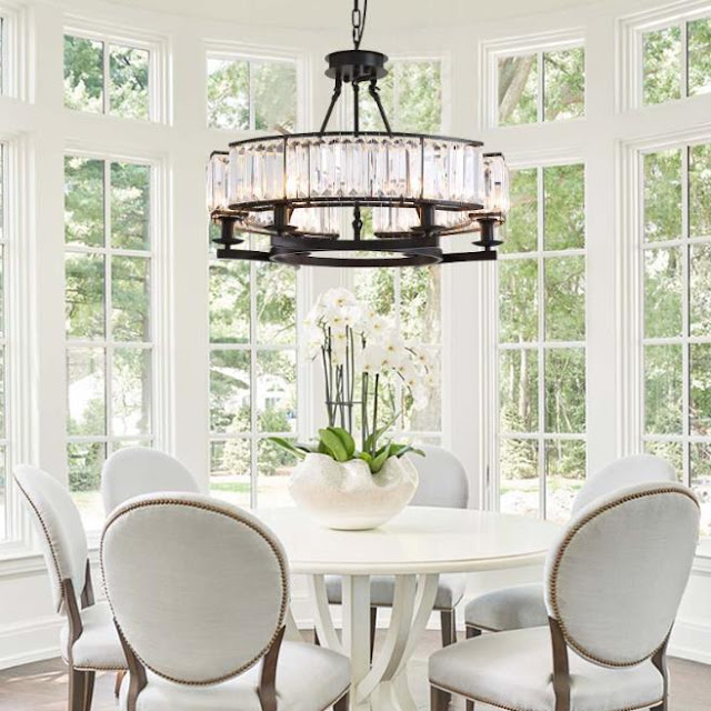 A Farmhouse Dining Room With An Antique Chandelier