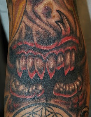 evil mouth tattoo with torn lip tattoo