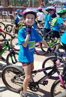 Girl with bicycle and attire for Telkom 947 Kiddies Ride