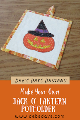 quilted and appliqued jack o lantern potholder with hanging loop
