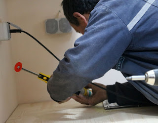 Bekir seals the sink into place with silicon