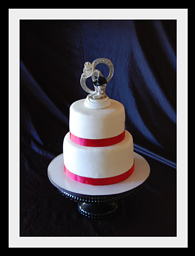 A 2 teir wedding cake with western topper An Alamo themed Anniversary cake