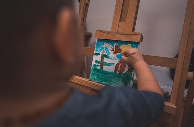 Child painting on a small canvass