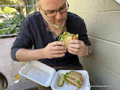 vegan eating a Killer B.L.A.T. sandwich from The Butcher's Son in Berkeley, California