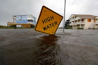 Flood waters lap at a high water warning sign that was partially pushed over by Hurricane Florence on Oak Island, North Carolina, U.S., September 15, 2018. (Credit: © Reuters/Jonathan Drake) Click to Enlarge.