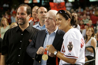 Misty May shows off her gold medal to John McCain