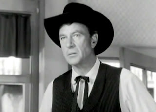 Gary Cooper wearing black hat in screen High Noon